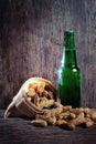 Peanuts and beer on wood background Royalty Free Stock Photo