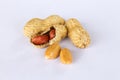 Peanuts isolated on white background . Two kernels are already unpacked. One of the peanuts, which was removed, revealed a red Royalty Free Stock Photo