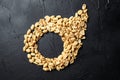 Peanuts, salty beer snack on black table, top view Royalty Free Stock Photo