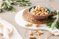 Peanuts with shell, dry roasted and unshelled peanuts as healthy snack in ceramic bowl in kitchen countertop. For healthy food and Royalty Free Stock Photo