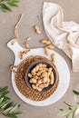 Peanuts with shell, dry roasted and unshelled peanuts as healthy snack in ceramic bowl in kitchen countertop. For healthy food and Royalty Free Stock Photo