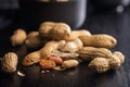 Peanuts in shell. Groundnuts on black table Royalty Free Stock Photo