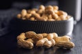 Peanuts in shell. Groundnuts on black table Royalty Free Stock Photo