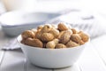 Peanuts in shell. Groundnuts in bowl on white table Royalty Free Stock Photo