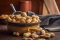 Peanuts in shell. Groundnuts in bowl on wooden table Royalty Free Stock Photo