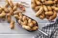 Peanuts in shell. Groundnuts in scoop on white table. Top view Royalty Free Stock Photo