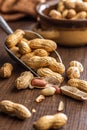 Peanuts in shell. Groundnuts in scoop on wooden table Royalty Free Stock Photo