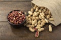 Peanuts in shell and peeled peanuts in a bowl on a wooden table. Beer snacks. Healthy food concept Royalty Free Stock Photo