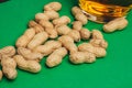 peanuts in shells snack Green background snack for alcohol Royalty Free Stock Photo