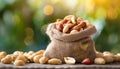 Peanuts in small burlap bag. Tasty and healthy snack. Natural backdrop