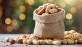 Peanuts in small burlap bag. Tasty and healthy snack. Natural backdrop