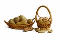 Peanuts in small wicker baskets and isolated on white Royalty Free Stock Photo