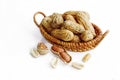 Peanuts in small wicker baskets and isolated on white Royalty Free Stock Photo