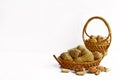 Peanuts in small wicker baskets and isolated on white Royalty Free Stock Photo