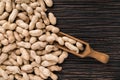 Peanuts on textured wooden background, top view.