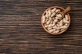 Peanuts on textured wooden background, top view.