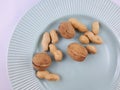 Peanuts and walnuts on green plate Royalty Free Stock Photo