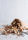 Peanuts, walnuts are in a yuta bag on a delicate background Royalty Free Stock Photo