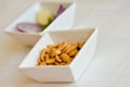 Peanuts in a white ceramic bowl