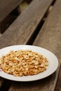 Peanuts in white plate on a wood background Royalty Free Stock Photo