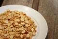 Peanuts in white plate on a wood background Royalty Free Stock Photo