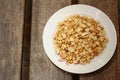 Peanuts in white plate on a wood background Royalty Free Stock Photo