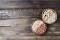 Peanuts on a wooden background. Unpeeled, peeled and salted peanuts