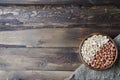 peanuts on wooden background. Unpeeled, peeled and salted peanuts