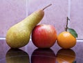 Pear, apple and tangerine still life Royalty Free Stock Photo