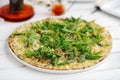 Pear arugula pizza