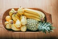 Pear, banana and pineapple in a wood basket