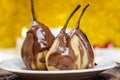 Pear in chocolate, yellow background