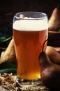 Pear cider in a large beer glass, vintage wooden background, selective focus