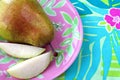 Pear on colorful floral plate