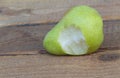 A pear fruit eaten on a wooden background close up