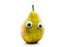 Pear with google eyes on a white backdrop