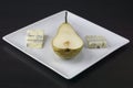 Pear half with cheese in a plate