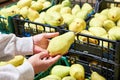 Pear in hands of buyer in store Royalty Free Stock Photo