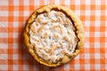 Pear pie with cream, homemade pastries on the table with a orange napkin. Copy space