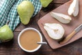 Pear puree in a white bowl next to fresh ripe pears on a wooden brown table. Royalty Free Stock Photo