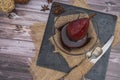 Pear with red wine served in a glass bowl on a slab in rustic presentation on a wooden table. Aerial view Royalty Free Stock Photo