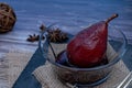 Pear with red wine served in a glass bowl on a slab in rustic presentation on a wooden table. dive view, close-up Royalty Free Stock Photo