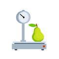 Pear on scale. Weighing of fruit.