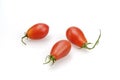 Pear-shaped tomatoes with cuttings. Pink oval shaped tomatoes