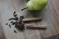 Pear and spices on wooden cutting board