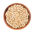 Pearl barley grains in wooden bowl, isolated on white background. Barley seed close up. Top view. Royalty Free Stock Photo