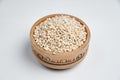 Pearl barley grains in a wooden bowl on a white background Royalty Free Stock Photo