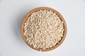 Pearl barley grains in a wooden bowl on a white background Royalty Free Stock Photo