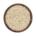 Pearl barley groats in wooden bowl isolated on white background, top view Royalty Free Stock Photo