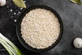 Pearl Barley Heap, on black dark stone table background, top view flat lay Royalty Free Stock Photo